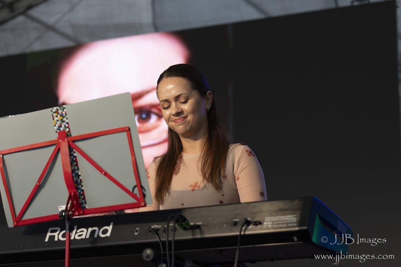 Piano teacher performing at the keyboard